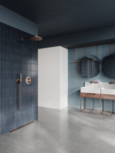 Open plan leaving bathroom with a level access shower area. Blue vintage subway tiles on the wall with large format tiles on the floor. Two Black Mirrors over the double sink